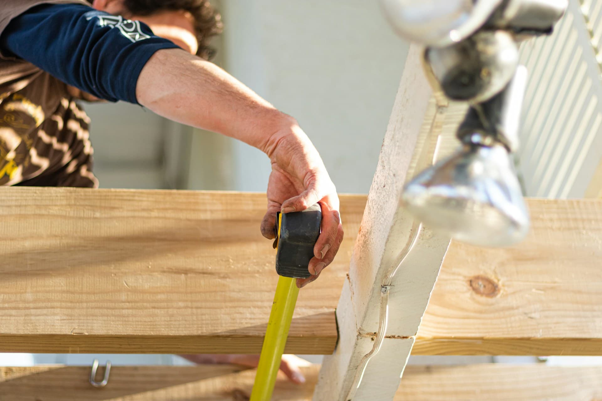 carpenter measuring wood